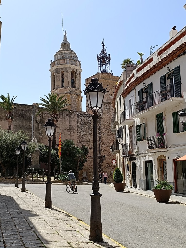 Picturesque view of Sitges Old Town with winding streets and Mediterranean-style homes.