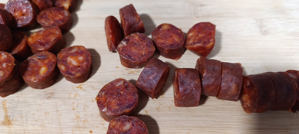 ices of Spanish chorizo arranged on a cutting board, ready to be cooked.