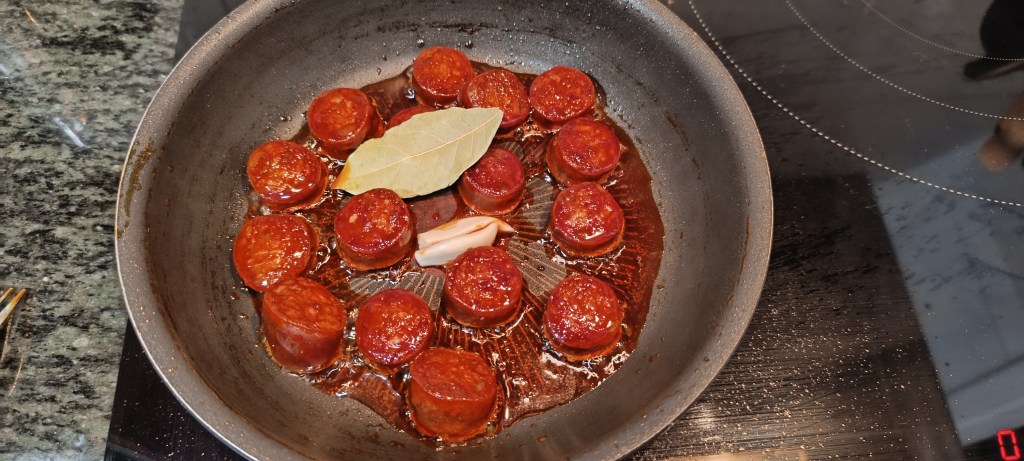  Garlic cloves lightly sautéing in olive oil in a pan until fragrant.
