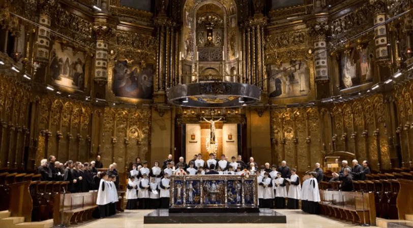 Inside Montserrat Cathedral, the famous Escolania boysโ choir performs beneath the vaulted ceilings, filling the sacred space with harmonious voices in Catalunya, Spain
