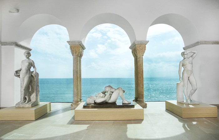 Elegant arched balcony at a Sitges museum, combining historic architecture with stunning ocean views