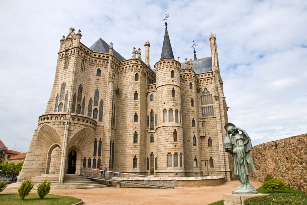 Exterior of the Palacio Episcopal, featuring classic architectural design with stone façade, arched windows, and decorative elements typical of an episcopal palace.