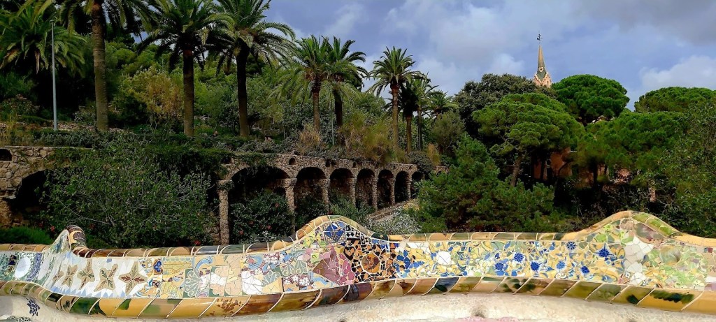 Colorful mosaic benches and architectural elements in Park Güell, a public park in Barcelona designed by Antoni Gaudí.