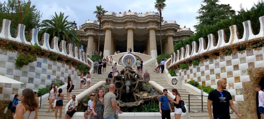 Panoramic view of Barcelona from Park Güell, with vibrant mosaic structures and Gaudí’s unique Modernisme style.