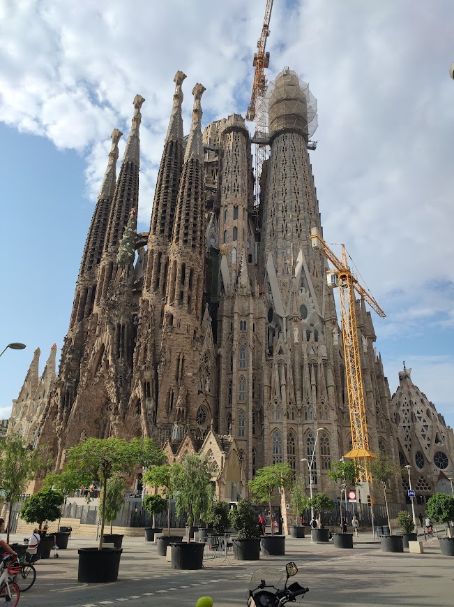 Exterior view of the Sagrada Família basilica in Barcelona, showcasing its towering spires and intricate architecture designed by Antoni Gaudí