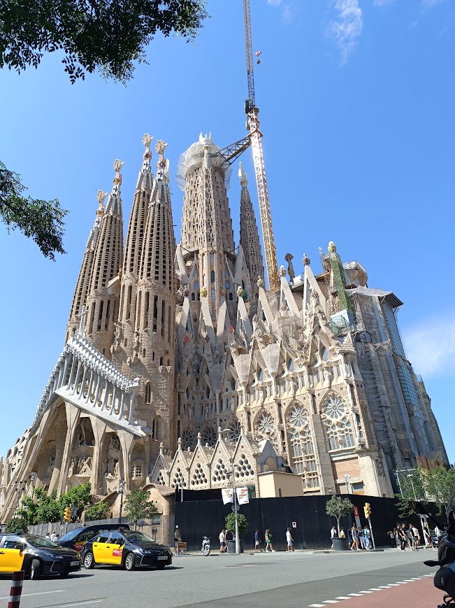 Exterior view of the Sagrada Família basilica in Barcelona, showcasing its towering spires and intricate architecture designed by Antoni Gaudí