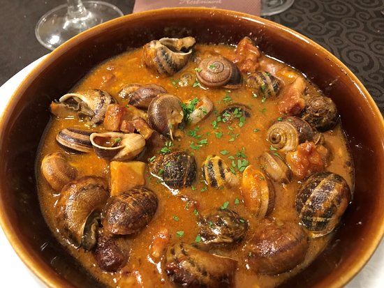 Grilled Catalan snails in a flavorful sauce, local delicacy