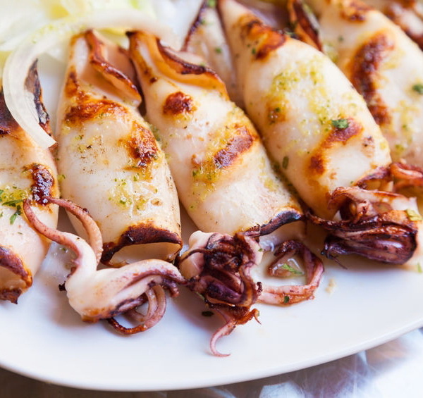 Grilled baby squid served with olive oil and lemon, typical northern Spain tapa
