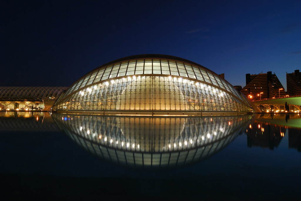 City of Arts and Sciences in Valencia at night, with lights reflecting on the water
