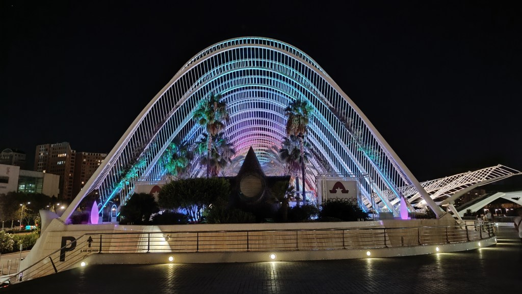 Night view of Valencia’s City of Arts and Sciences illuminated with colorful lights and reflections