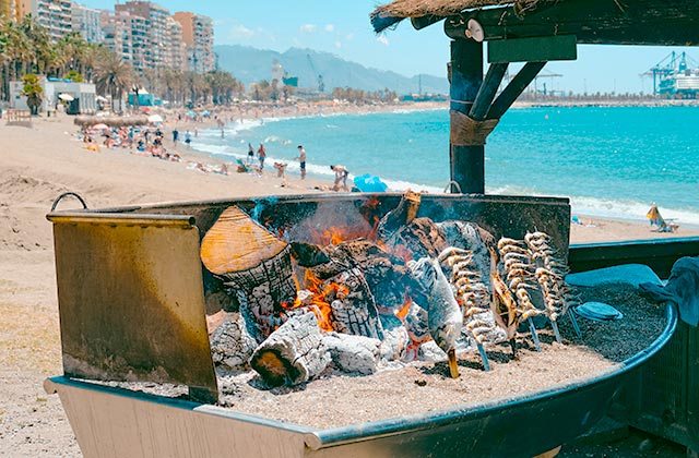 Andalusian chiringuito on the beach with sun, sand, and outdoor tables