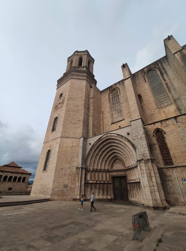 Medieval streets of Girona’s old town with Gothic architecture, stone buildings, and cathedral towers rising above