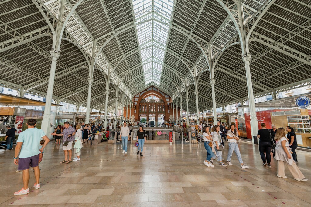 Interior of Mercado de Colón in Valencia, showcasing its grand architecture and shops