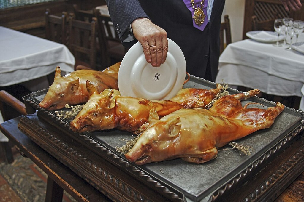 Segovia roast suckling pig with crispy skin served whole in a traditional restaurant