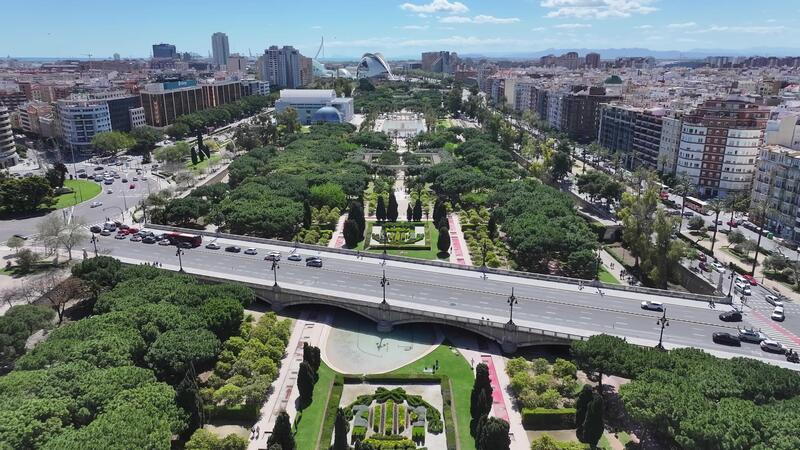 View of Turia Gardens with historic bridges and greenery in Valencia