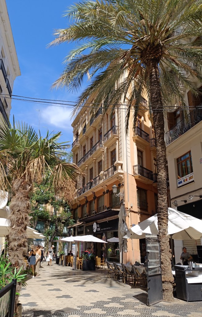 Pedestrian street in Valencia lined with traditional facades and street lamps