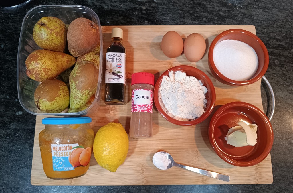 Easy pear pie recipe ingredients arranged on a countertop: fresh pears, flour, sugar, eggs, butter, cinnamon, vanilla, and peach jam.