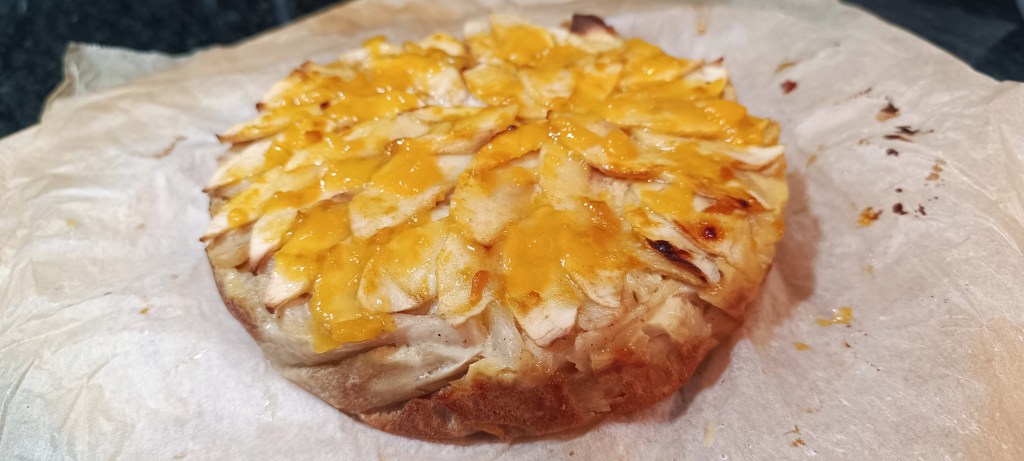 Finished baked pear pie brushed with peach jam for a shiny glaze before cooling to room temperature.
