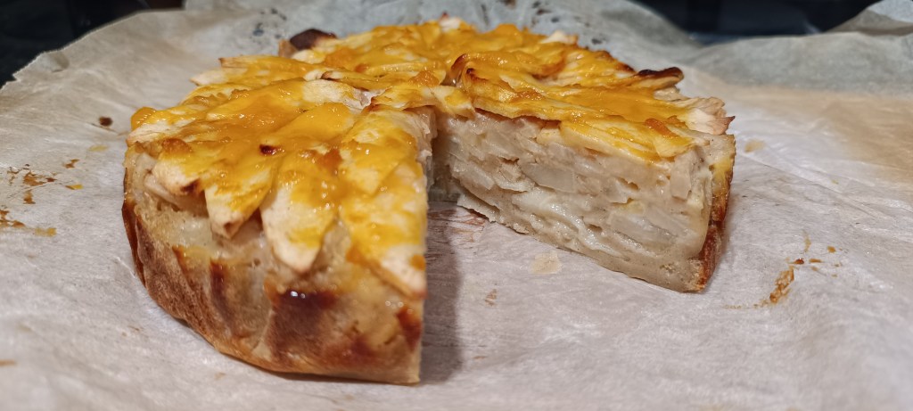Close-up of pear pie showing flaky crust and juicy filling.