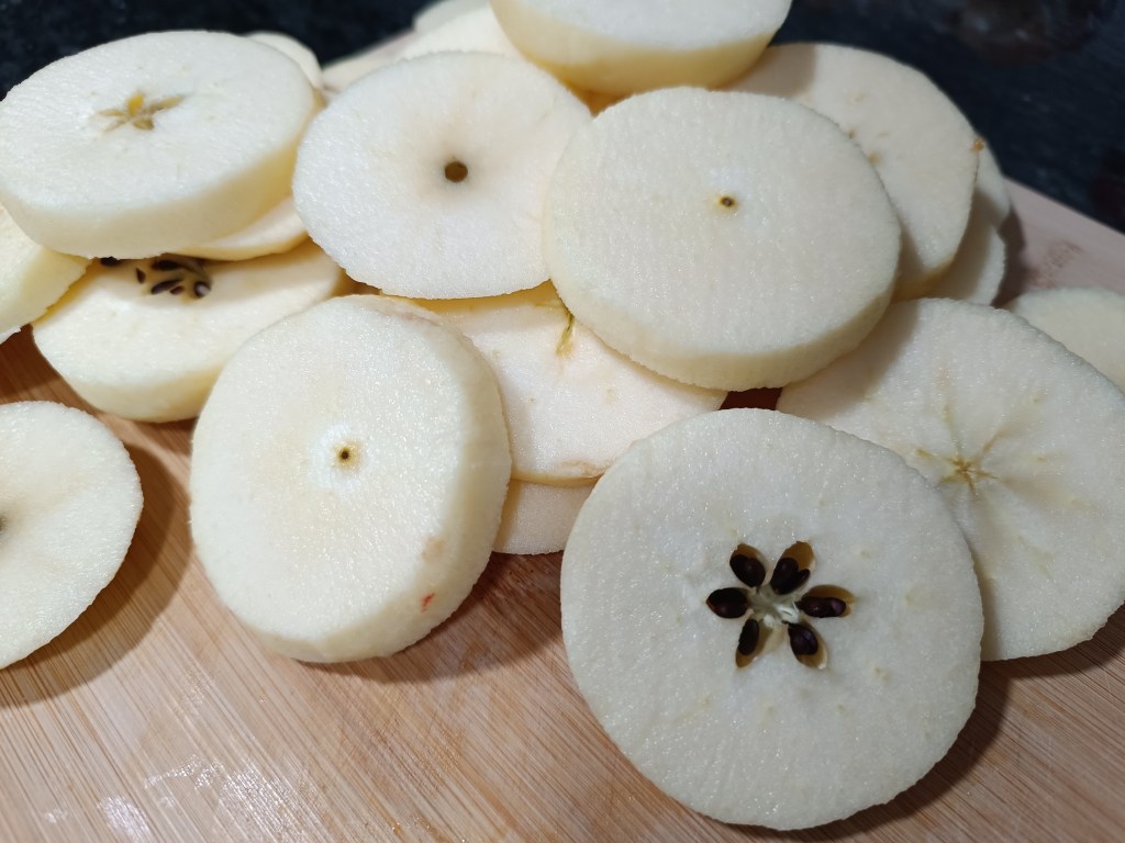 Peeling fresh apples to prepare for viral TikTok apple doughnuts