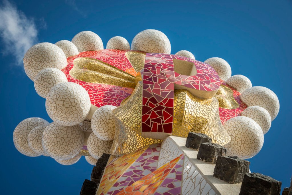 Close-up of a mosaic-covered tower spire at the Sagrada Familia