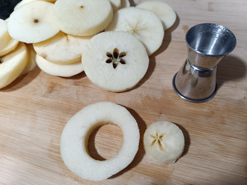 Slicing peeled apples into round rings for TikTok apple doughnut recipe