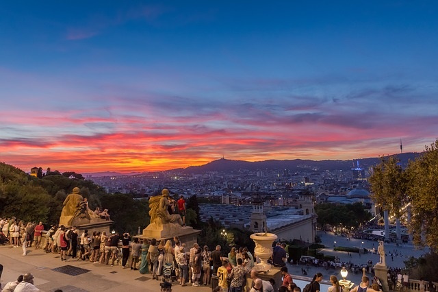 Sunset view from the steps of MNAC overlooking Barcelona with warm evening light.