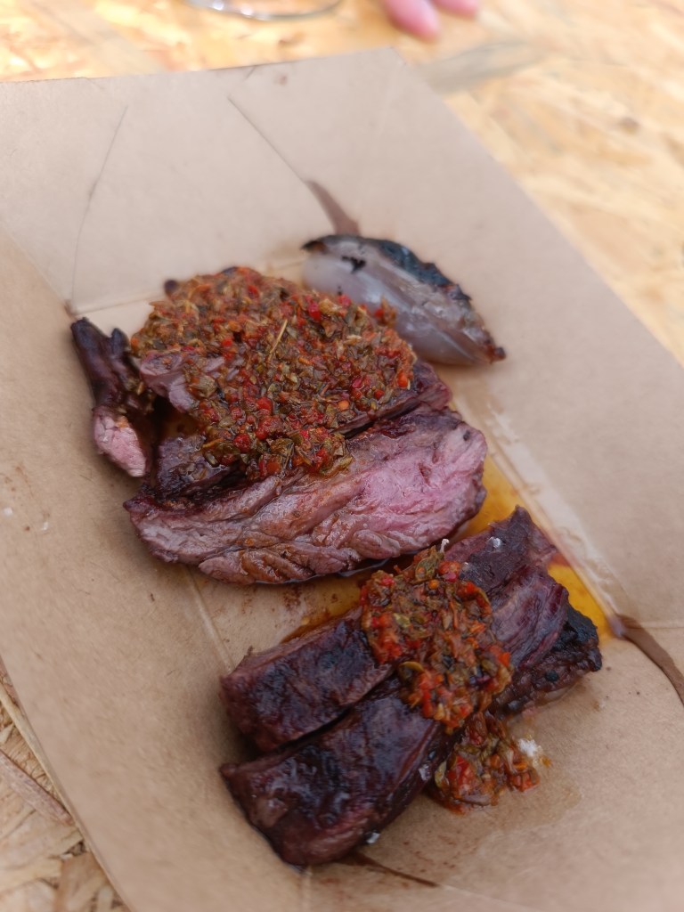 Smoke and fire filling the air as meat is cooked outdoors at Meat & Fire.