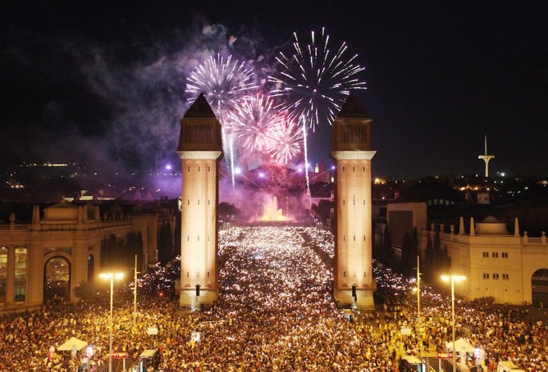Fireworks exploding over Barcelona during La Mercè festival at night.
