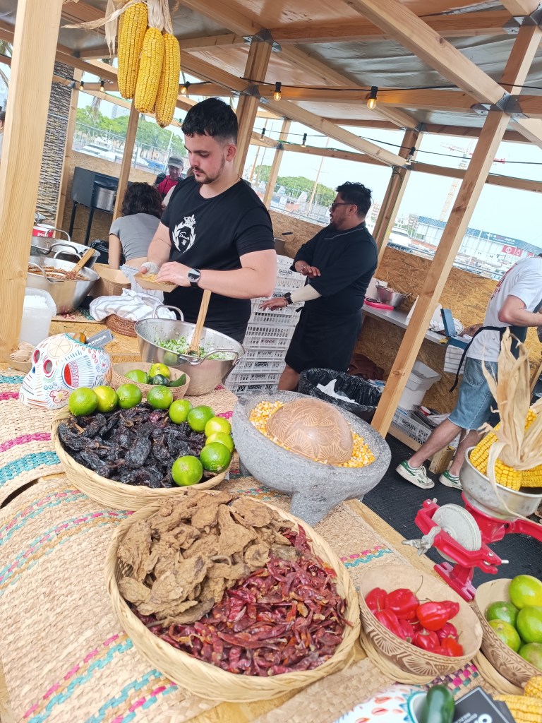 Chefs cooking meat over open flames during the Meat & Fire festival in Barcelona.