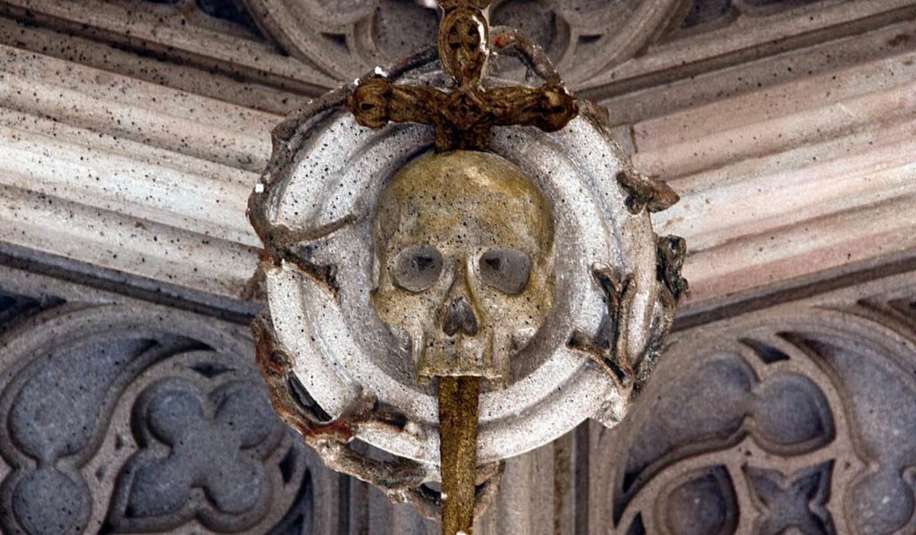 El Pont del Bisbe neo-Gothic bridge in Barcelona Gothic Quarter with skull and dagger carving legend