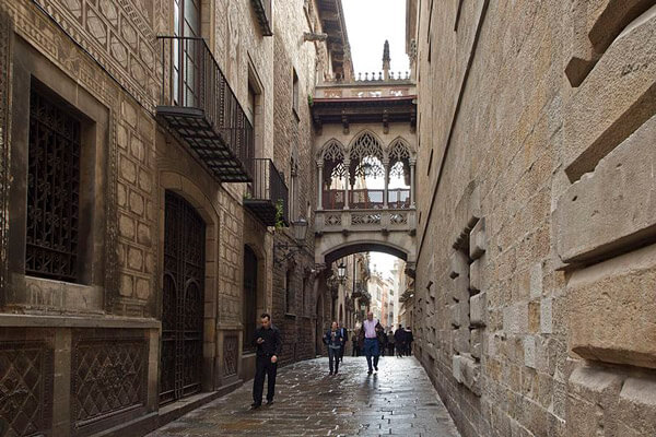 El Pont del Bisbe neo-Gothic bridge in Barcelona Gothic Quarter with skull and dagger carving legend