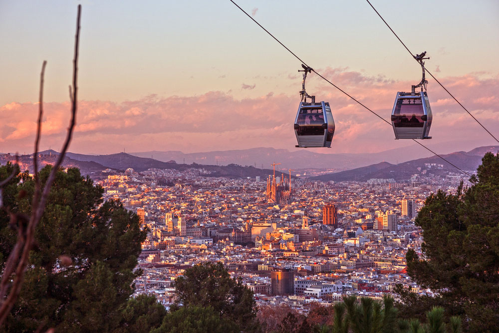 Golden hour view from Montjuรฏc with harbor views and layered city scenery.