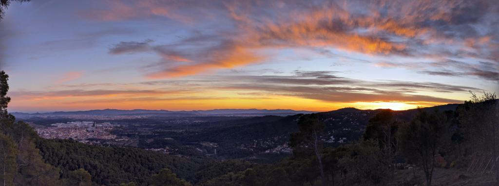 360-degree sunset view from Tibidabo Hill showing sky, city, and sea all in one frame.