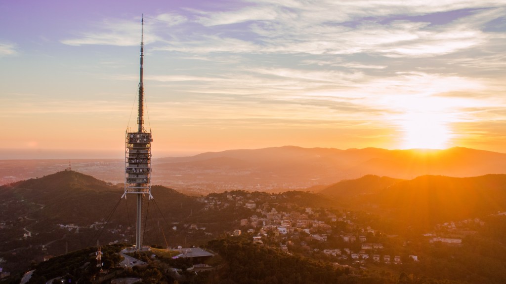 360-degree sunset view from Tibidabo Hill showing sky, city, and sea all in one frame.