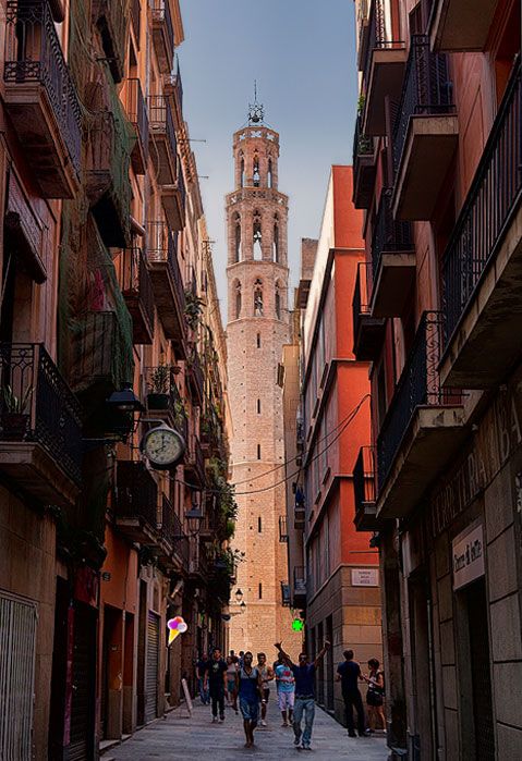 Winding narrow streets of Barcelona’s Gothic Quarter, with medieval buildings on either side