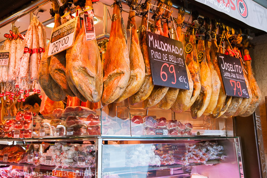 Assortment of cheeses and cured meats at a traditional market stall