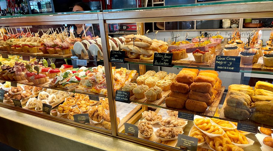Bakery stall with pastries and bread in a bustling Barcelona market