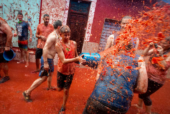 Tomato-covered streets during La Tomatina festival in Spain